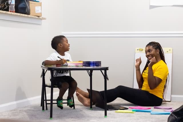 Child laughing with an educator