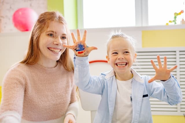 Educator helping children with a craft activity